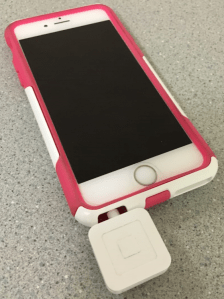 Photo of Square reader attached to iPhone